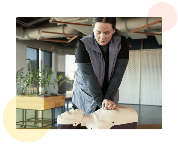 A person performing CPR on a Manikin